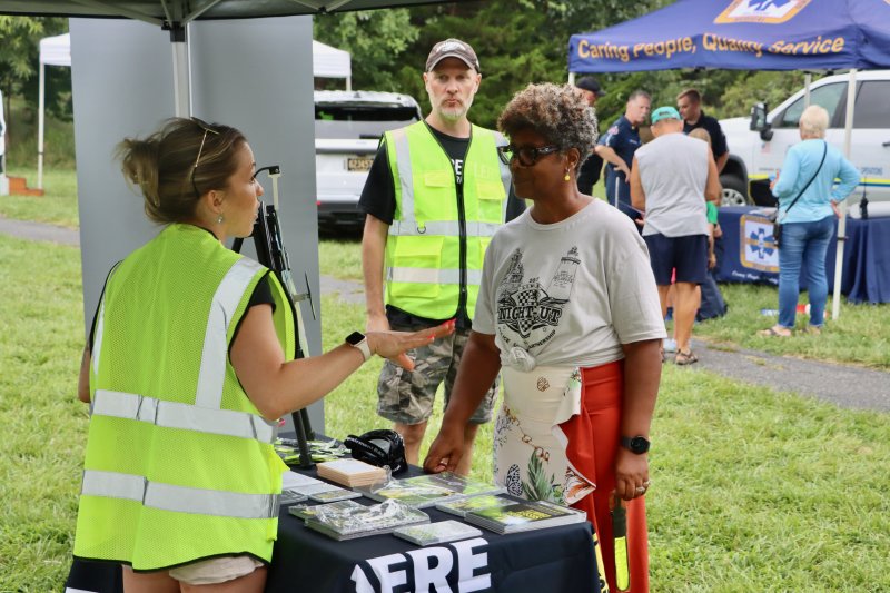 Lewes Councilwoman Trina Brown-Hicks talks with a representative from the Delaware Office of Highway Safety.